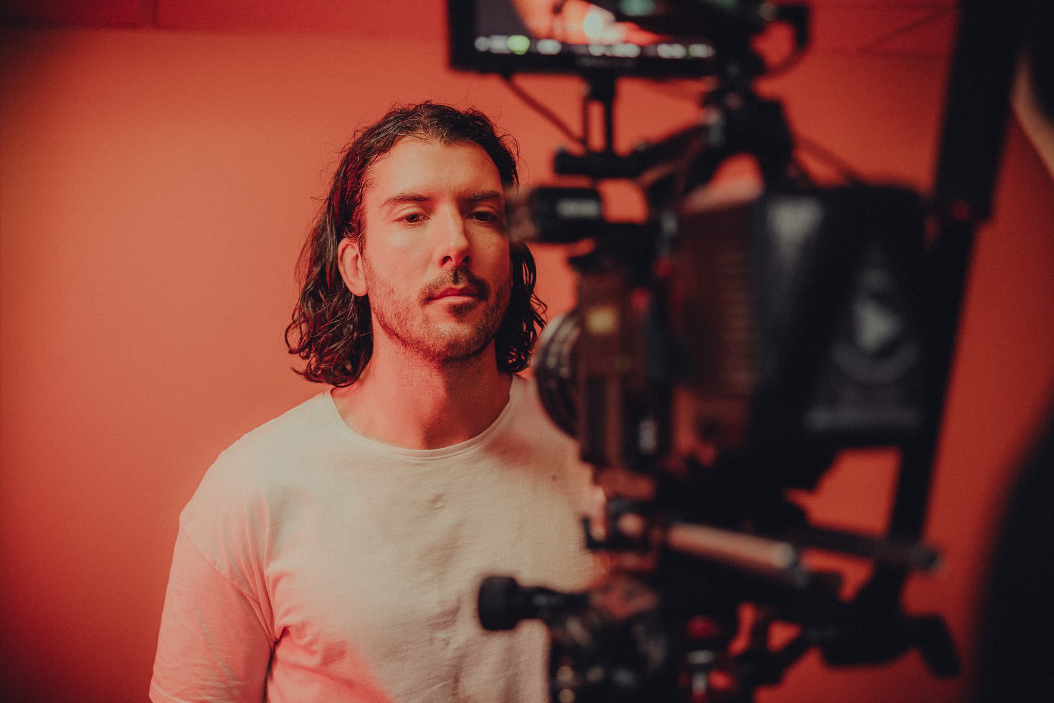 A crew member watching a scene closely during a shoot