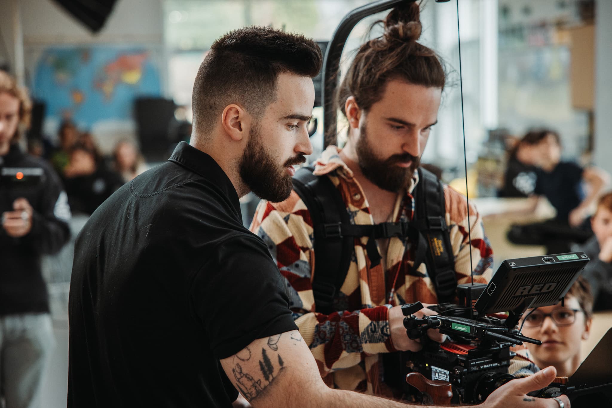 Two crew members discussing at the monitor during a shoot